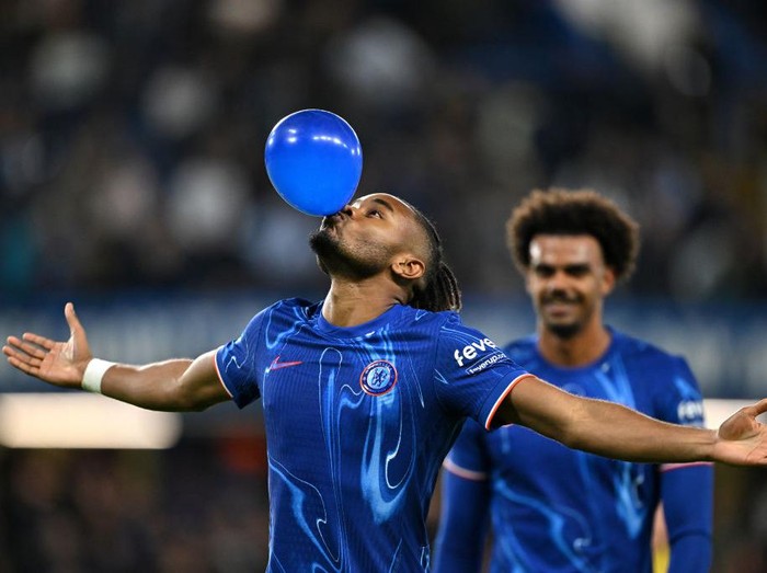 LONDON, ENGLAND - SEPTEMBER 24: Christopher Nkunku of Chelsea celebrates scoring his team's fifth goal, and completing his hattrick by blowing up a ballon during the Carabao Cup Third Round match between Chelsea and Barrow at Stamford Bridge on September 24, 2024 in London, England. (Photo by Mike Hewitt/Getty Images)