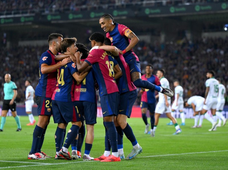 BARCELONA, SPAIN - SEPTEMBER 25: Robert Lewandowski of FC Barcelona (obscured) celebrates scoring his team's first goal with teammates during the La Liga EA Sports match between FC Barcelona and Getafe CF  at Camp Nou on September 25, 2024 in Barcelona, Spain. (Photo by David Ramos/Getty Images)