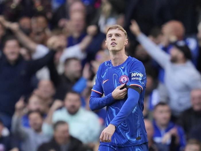 Chelsea's Cole Palmer celebrates after scoring his side's 3rd goal during a British Premier League soccer match between Chelsea and Brighton at Stamford Bridge, London, Saturday, Sept. 28, 2024. (AP Photo/Kin Cheung)