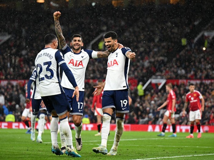 MANCHESTER, ENGLAND - SEPTEMBER 29: Dominic Solanke of Tottenham Hotspur celebrates scoring his team's third goal with teammates Pedro Porro and Cristian Romero during the Premier League match between Manchester United FC and Tottenham Hotspur FC at Old Trafford on September 29, 2024 in Manchester, England. (Photo by Michael Regan/Getty Images)