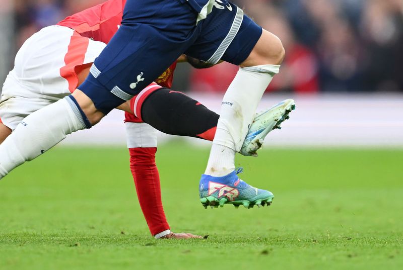 MANCHESTER, ENGLAND - SEPTEMBER 29: James Maddison of Tottenham Hotspur is fouled by Bruno Fernandes of Manchester United, which results in a red card during the Premier League match between Manchester United FC and Tottenham Hotspur FC at Old Trafford on September 29, 2024 in Manchester, England. (Photo by Michael Regan/Getty Images)