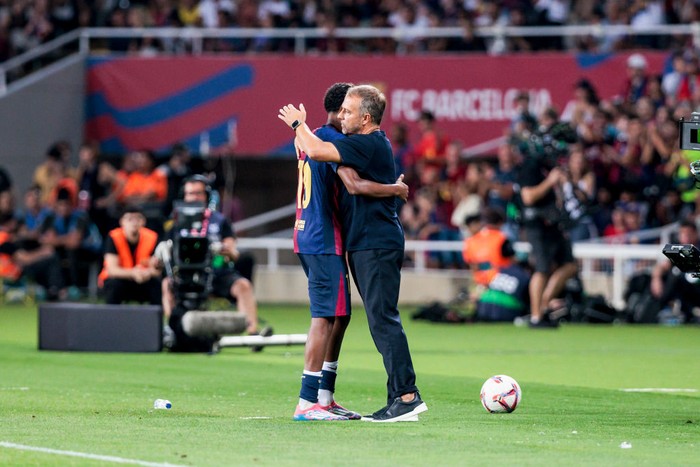 BARCELONA, SPAIN - AUGUST 24: Lamine Yamal of FC Barcelona is congratulated by Hansi Flick, head coach of FC Barcelona during the Spanish league, La Liga EA Sports, football match played between FC Barcelona and Athletic Club de Bilbao at Estadio Olimpico de Montjuic on August 24, 2024 in Barcelona, Spain. (Photo By Javier Borrego Ramos/Europa Press via Getty Images)