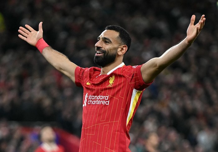 Liverpools Egyptian striker #11 Mohamed Salah celebrates scoring the teams second goal  during the UEFA Champions League league stage football match between Liverpool and Bologna at Anfield in Liverpool, north west England on October 2, 2024. (Photo by Paul ELLIS / AFP)