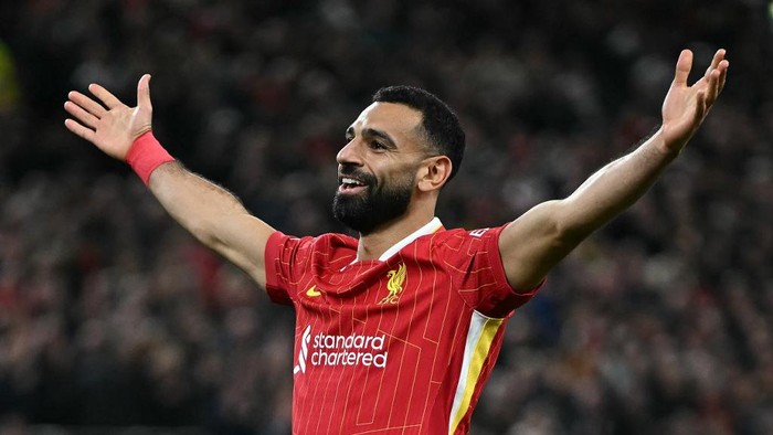 Liverpools Egyptian striker #11 Mohamed Salah celebrates scoring the teams second goal  during the UEFA Champions League league stage football match between Liverpool and Bologna at Anfield in Liverpool, north west England on October 2, 2024. (Photo by Paul ELLIS / AFP)