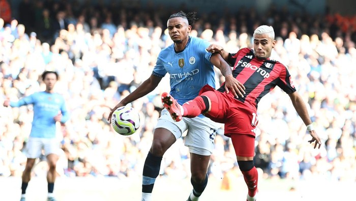 MANCHESTER, ENGLAND - OCTOBER 05: Andreas Pereira of Fulham scores his teams first goal whilst under pressure from Manuel Akanji of Manchester City during the Premier League match between Manchester City FC and Fulham FC at Etihad Stadium on October 05, 2024 in Manchester, England. (Photo by Gareth Copley/Getty Images)