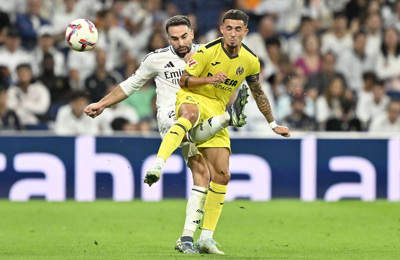 MADRID, SPAIN - OCTOBER 05: Dani Carvajal (L) of Real Madrid in action against Yeremi Pino (R) of Villarreal during LaLiga match between Real Madrid and Villarreal at Santiago Bernabeu Stadium in Madrid, Spain on October 05, 2024. (Photo by Burak Akbulut/Anadolu via Getty Images)