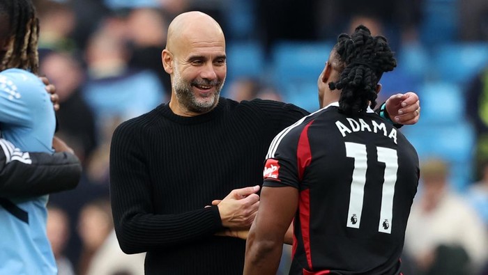 MANCHESTER, ENGLAND - OCTOBER 5: Pep Guardiola Manager of Manchester City and Adama Traore of Fulham during the Premier League match between Manchester City FC and Fulham FC at Etihad Stadium on October 5, 2024 in Manchester, England. (Photo by Neal Simpson/Sportsphoto/Allstar via Getty Images)