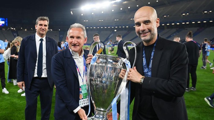 ISTANBUL, TURKEY - JUNE 10: Manchester City director of football Txiki Begiristain and Manchester City manager Pep Guardiola pose with the trophy during the UEFA Champions League 2022/23 final match between FC Internazionale and Manchester City FC at Ataturk Olympic Stadium on June 10, 2023 in Istanbul, Turkey. (Photo by Michael Regan - UEFA/UEFA via Getty Images)