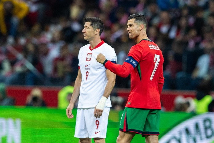 Cristiano Ronaldo reacts after scoring a goal while Robert Lewandowski looks on during the UEFA 2024 UEFA Nations League Group A1 match between Poland and Portugal at the PGE Narodowe in Warsaw, Poland, 12 October 2024. (Photo by Andrzej Iwanczuk/NurPhoto via Getty Images)
