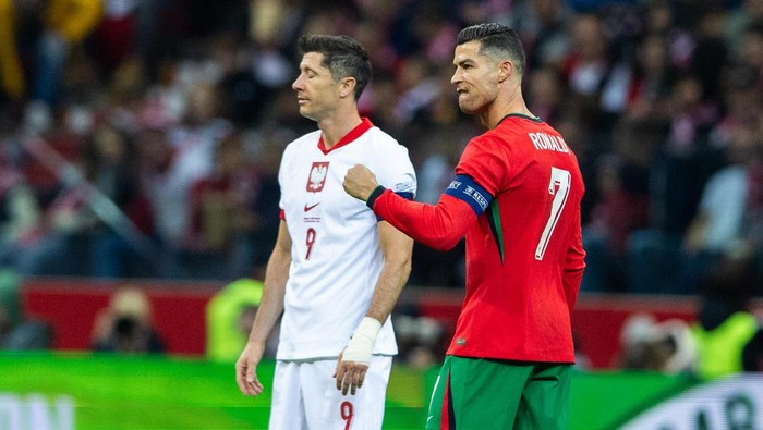 Cristiano Ronaldo reacts after scoring a goal while Robert Lewandowski looks on during the UEFA 2024 UEFA Nations League Group A1 match between Poland and Portugal at the PGE Narodowe in Warsaw, Poland, 12 October 2024. (Photo by Andrzej Iwanczuk/NurPhoto via Getty Images)