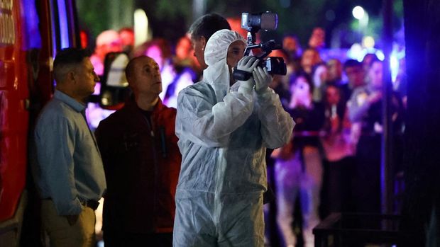 A forensic technician uses a video camera outside the hotel where Liam Payne, former One Direction member, was found dead, in Buenos Aires, Argentina, October 16, 2024. REUTERS/Agustin Marcarian