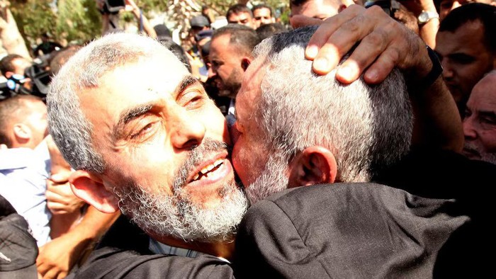 Freed Hamas top security strategist Yehya Al-Sinwar is hugged by senior Hamas leader Ismail Haniyeh (R) upon his arrival at the Rafah crossing with Egypt in the southern Gaza Strip October 18, 2011. REUTERS/Mohammed Salem/File Photo Purchase Licensing Rights