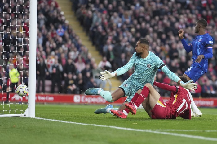 LIverpool, chelsea, Robert Sanchez Liverpool's Curtis Jones, right, scores his side's second goal past Chelsea's goalkeeper Robert Sanchez during the English Premier League soccer match between Liverpool and Chelsea at Anfield Stadium, Liverpool, England, Sunday, Oct. 20, 2024. (AP Photo/Jon Super)