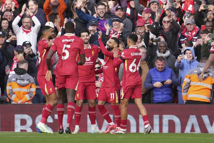 Liverpools Mohamed Salah, centre right, celebrates with teammates after scoring his sides opening goal during the English Premier League soccer match between Liverpool and Chelsea at Anfield Stadium, Liverpool, England, Sunday, Oct. 20, 2024. (AP Photo/Jon Super)