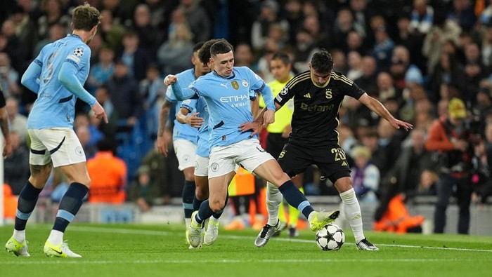 Manchester Citys Phil Foden (left) and Sparta Prahas Qazim Laci battle for the ball during the UEFA Champions League group stage match at the Etihad Stadium, Manchester. Picture date: Wednesday October 23, 2024. (Photo by Martin Rickett/PA Images via Getty Images)