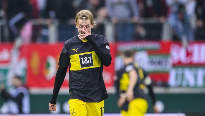 26 October 2024, Bavaria, Augsburg: Soccer, Bundesliga, FC Augsburg - Borussia Dortmund, Matchday 8, WWK-Arena. Dortmunds Julian Brandt reacts dissatisfied. Photo: Tom Weller/dpa - IMPORTANT NOTE: In accordance with the regulations of the DFL German Football League and the DFB German Football Association, it is prohibited to utilize or have utilized photographs taken in the stadium and/or of the match in the form of sequential images and/or video-like photo series. (Photo by Tom Weller/picture alliance via Getty Images)