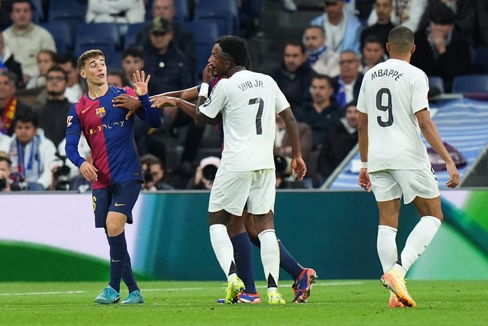 MADRID, SPAIN - OCTOBER 26: Gavi of FC Barcelona and Vinicius Junior of Real Madrid clash during the LaLiga match between Real Madrid CF and FC Barcelona at Estadio Santiago Bernabeu on October 26, 2024 in Madrid, Spain. (Photo by Angel Martinez/Getty Images)