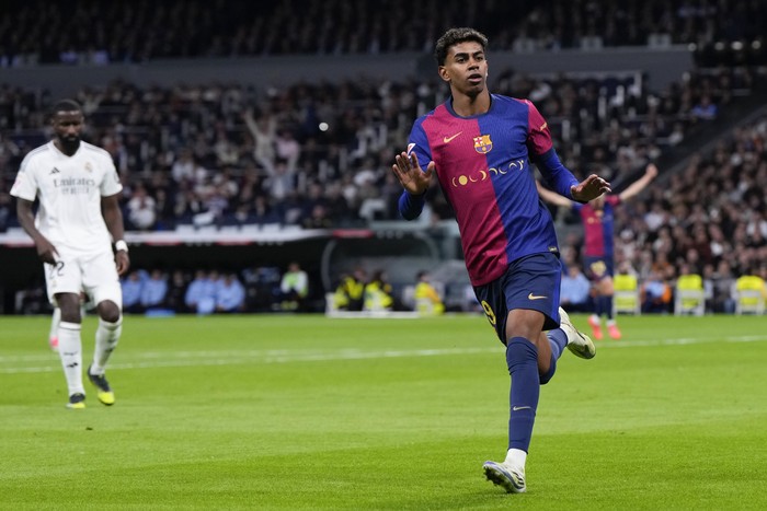 Barcelonas Lamine Yamal celebrates after scoring his sides third goal during a Spanish La Liga soccer match between Real Madrid and Barcelona at the Santiago Bernabeu stadium in Madrid, Spain, Saturday, Oct. 26, 2024. (AP Photo/Manu Fernandez)