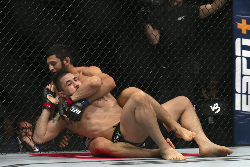 Khamzat Chimaev celebrates his win over Robert Whittaker in a middleweight mixed martial arts bout at UFC Fight Night on Saturday, Oct. 26, 2024, in Abu Dhabi, United Arab Emirates. (AP Photo/Altaf Qadri)