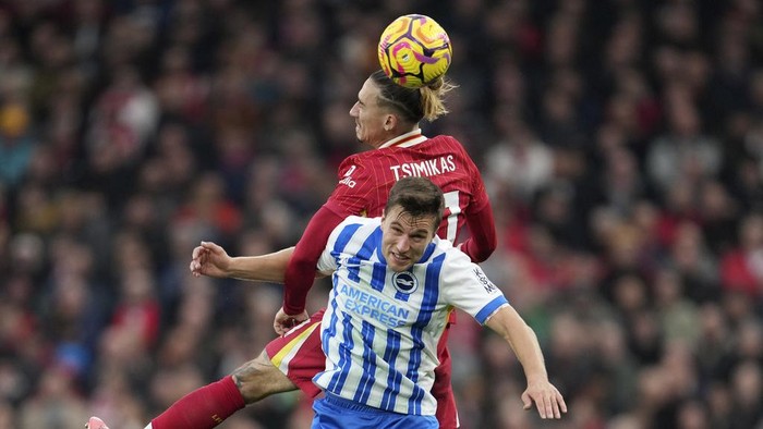 Liverpools Kostas Tsimikas, top, jumps for the ball with Brightons Joel Veltman during the English Premier League soccer match between Liverpool and Brighton at the Anfield stadium in Liverpool, England, Saturday, Nov. 2, 2024. (AP Photo/Jon Super)