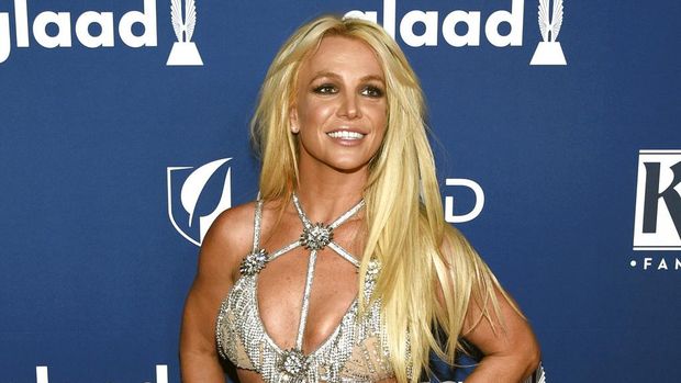 FILE - In this April 12, 2018 file photo, Britney Spears arrives at the 29th annual GLAAD Media Awards in Beverly Hills, Calif. Spears is putting her planned Las Vegas residency on hold to focus on her father's recovery from a recent life-threatening illness. The pop superstar announced Friday, Jan. 4, 2019 she is going on an indefinite work hiatus. (Photo by Chris Pizzello/Invision/AP, File)
