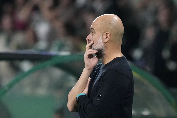 Manchester Citys head coach Pep Guardiola watches from the touchline during the Champions League opening phase soccer match between Sporting CP and Manchester City at the Alvalade stadium in Lisbon, Tuesday, Nov. 5, 2024. (AP Photo/Armando Franca)