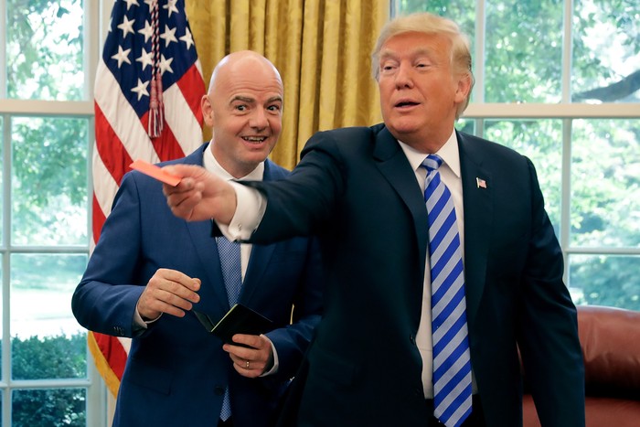 WASHINGTON, DC - AUGUST 28:  U.S. President Donald Trump pretends to give a red card to members of the news media with FIFA President Gianni Infantino in the Oval Office at the White House August 28, 2018 in Washington, DC. The 2026 FIFA World Cup wi