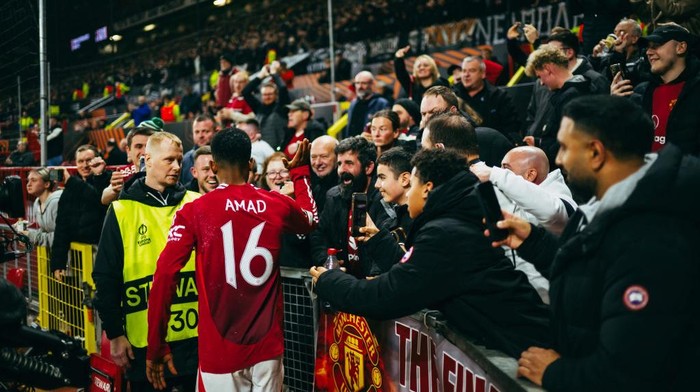 MANCHESTER, ENGLAND - NOVEMBER 07: Amad Diallo of Manchester United celebrates scoring his teams first goal with fans during the UEFA Europa League 2024/25 League Phase MD4 match between Manchester United and PAOK FC at Old Trafford on November 07, 2024 in Manchester, England. (Photo by Ash Donelon/Manchester United via Getty Images)