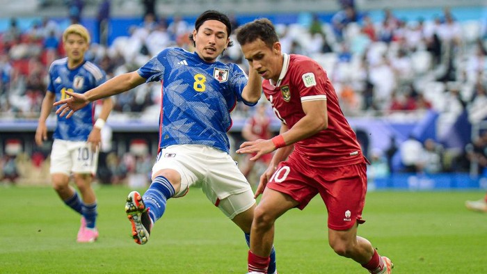 DOHA, QATAR - JANUARY 24: Takumi Minamino #8 of Japan and Egy Maulana Vikri #10 of Indonesia compete for the ball during the AFC Asian Cup Qatar 2023 Group D match between Japan and Indonesia at the Al Thumama Stadium on January 24, 2024 in Doha, Qatar. (Photo by Gao Meng/VCG via Getty Images)