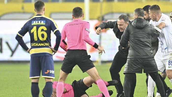 ANKARA, TURKIYE - DECEMBER 11: Referee Halil Umut Meler falls to the ground after Faruk Koca, President of MKE Ankaragucu throws a punch to him after the Turkish Super Lig week 15 soccer match between MKE Ankaragucu and Rizespor at Eryaman Stadium in Ankara, Turkiye on December 11, 2023. The match ended 1-1. (Photo by Emin Sansar/Anadolu via Getty Images)