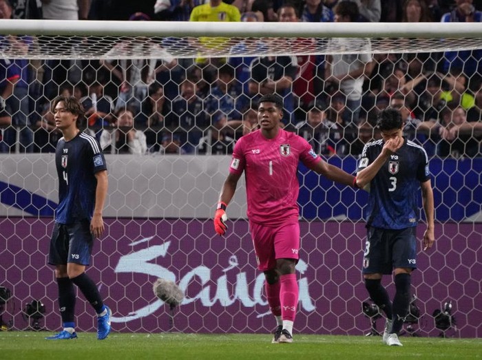 SAITAMA, JAPAN - OCTOBER 15: Zion Suzuki of Japan comforts Shogo Taniguchi of Japan for the own goal during the FIFA World Cup Asian 3rd Qualifier Group C match between Japan and Australia at Saitama Stadium on October 15, 2024 in Saitama, Japan. (Photo by Kaz Photography/Getty Images)