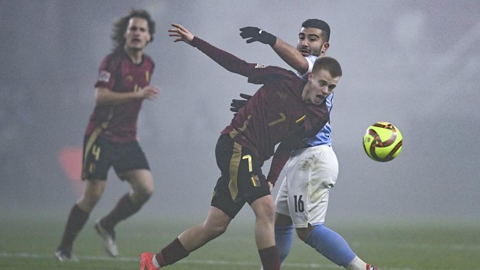 Belgiums Arthur Vermeeren is challenged by Israels Mohammad Abu Fani, right, during the UEFA Nations League Group A2 soccer match between Israel and Belgium at the Bozsik Arena stadium in Budapest, Hungary, Sunday, Nov. 17, 2024. (AP Photo/Denes Erdos)