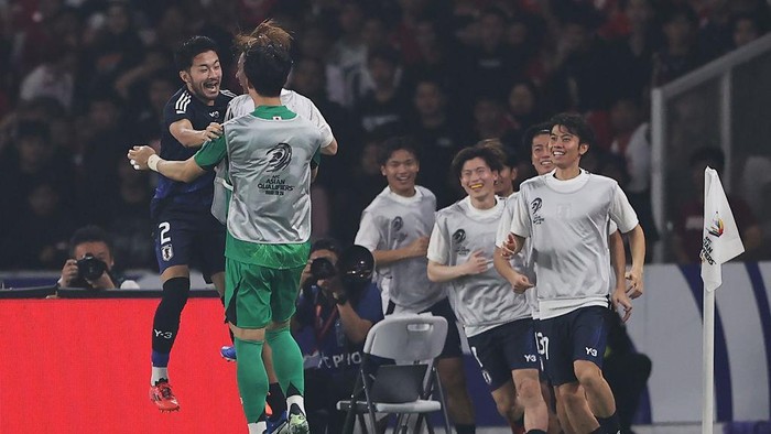 JAKARTA, INDONESIA - NOVEMBER 15: Yukinari Sugawara (L) of Japan celebrates with teammates after scoring the team's fourth goal against Indonesia in the second half during the FIFA World Cup Asian 3rd Qualifier Group C match at Gelora Bung Karno Stadium on November 15, 2024 in Jakarta, Indonesia.  (Photo by Robertus Pudyanto/Getty Images)