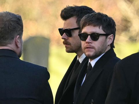 Former One Direction band members Harry Styles (C) and Niall Horan leave after attending the funeral service of the late One Direction singer Liam Payne, at a St Mary's church in Amersham, west of London on November 20, 2024. The funeral of former One Direction singer Liam Payne who died last month after falling from his Buenos Aires hotel room was held on Wednesday. (Photo by JUSTIN TALLIS / AFP)