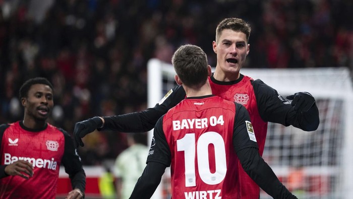 Leverkusens scorer Patrik Schick, right, and his teammate Florian Wirtz celebrate their sides third goal during the German Bundesliga soccer match between  Bayer 04 Leverkusen and 1. FC Heidenheim 1846 in Leverkusen, Germany, Saturday, Nov. 23, 2024. (Marius Becker/dpa via AP)