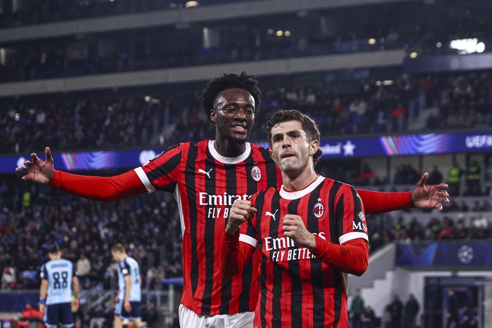 BRATISLAVA, SLOVAKIA - NOVEMBER 26: Christian Pulisic of AC Milan celebrates with Tammy Abraham after scoring the his teams first goal during the UEFA Champions League 2024/25 League Phase MD5 match between SK Slovan Bratislava and AC Milan at Narodny Futbalovy Stadion on November 26, 2024 in Bratislava, Slovakia. (Photo by Giuseppe Cottini/AC Milan via Getty Images)