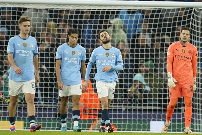 Manchester City, Manchester City's Bernardo Silva, second right, reacts after Feyenoord scored their third goal during the Champions League opening phase soccer match between Manchester City and Feyenoord at the Etihad Stadium in Manchester, England, Tuesday, Nov. 26, 2024. (AP Photo/Dave Thompson)