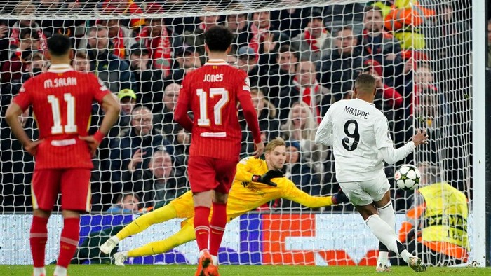 Liverpool goalkeeper Caoimhin Kelleher (rear) saves a penalty from Real Madrids Kylian Mbappe (right) during the UEFA Champions League, league stage match at Anfield, Liverpool. Picture date: Wednesday November 27, 2024. (Photo by Peter Byrne/PA Images via Getty Images)