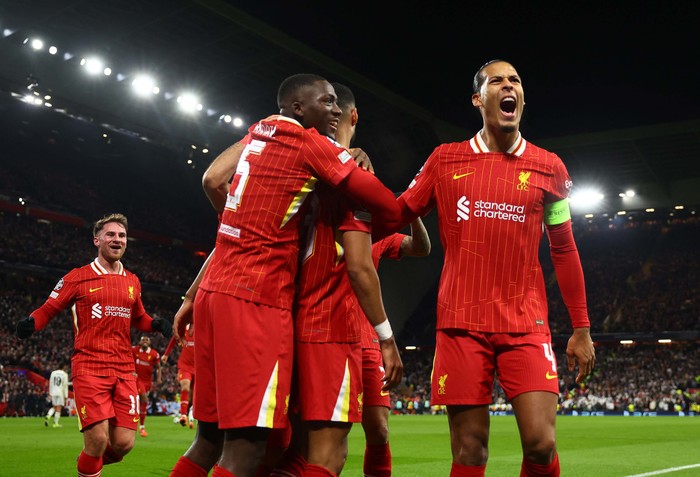 Soccer Football - Champions League - Liverpool v Real Madrid - Anfield, Liverpool, Britain - November 27, 2024
Liverpools Cody Gakpo celebrates scoring their second goal with Virgil van Dijk and Ibrahima Konate REUTERS/Molly Darlington