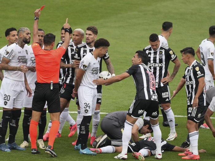 Referee Facundo Tello, of Argentina, shows the red card to Gregore of Brazil's Botafogo during a Copa Libertadores final soccer match at Monumental stadium in Buenos Aires, Argentina, Saturday, Nov. 30, 2024. (AP Photo/Natacha Pisarenko)