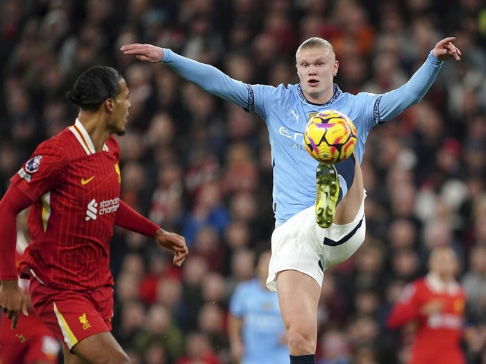 Manchester City's Erling Haaland contols the ball during the English Premier League soccer match between Liverpool and Manchester City at Anfield Stadium, Liverpool, England, Sunday Dec. 1, 2024.  (Peter Byrne/PA via AP)