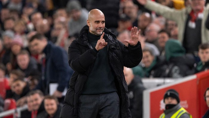 LIVERPOOL, ENGLAND - DECEMBER 1: Manchester City manager Pep Guardiola holds up six fingers to indicate the six premier league titles he has won after Liverpool fans sing Youre Getting Sacked it in Morning during the Premier League match between Liverpool FC and Manchester City FC at Anfield on December 1, 2024 in Liverpool, England. (Photo by Visionhaus/Getty Images)