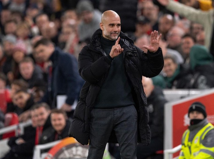 LIVERPOOL, ENGLAND - DECEMBER 1: Manchester City manager Pep Guardiola holds up six fingers to indicate the six premier league titles he has won after Liverpool fans sing 'You're Getting Sacked it in Morning' during the Premier League match between Liverpool FC and Manchester City FC at Anfield on December 1, 2024 in Liverpool, England. (Photo by Visionhaus/Getty Images)