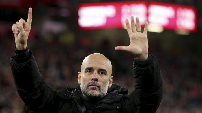 Manchester Citys head coach Pep Guardiola puts up six fingers to remind the jeering fans of his six Premier League titles at the end of the English Premier League soccer match between Liverpool and Manchester City at Anfield Stadium, Liverpool, England, Sunday Dec. 1, 2024. (AP Photo/Ian Hodgson)