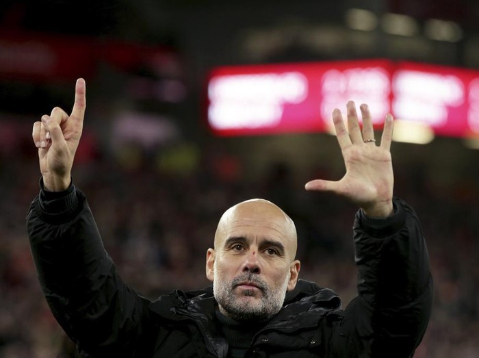 Manchester City's head coach Pep Guardiola puts up six fingers to remind the jeering fans of his six Premier League titles at the end of the English Premier League soccer match between Liverpool and Manchester City at Anfield Stadium, Liverpool, England, Sunday Dec. 1, 2024. (AP Photo/Ian Hodgson)