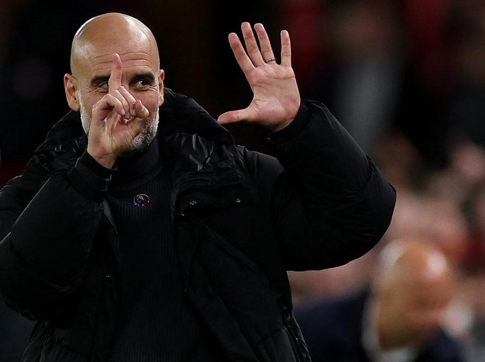 Manchester City's Spanish manager Pep Guardiola reacts to Liverpool fans chanting jeers during the English Premier League football match between Liverpool and Manchester City at Anfield in Liverpool, north west England on December 1, 2024. (Photo by Adrian Dennis / AFP) / RESTRICTED TO EDITORIAL USE. No use with unauthorized audio, video, data, fixture lists, club/league logos or 'live' services. Online in-match use limited to 120 images. An additional 40 images may be used in extra time. No video emulation. Social media in-match use limited to 120 images. An additional 40 images may be used in extra time. No use in betting publications, games or single club/league/player publications. /