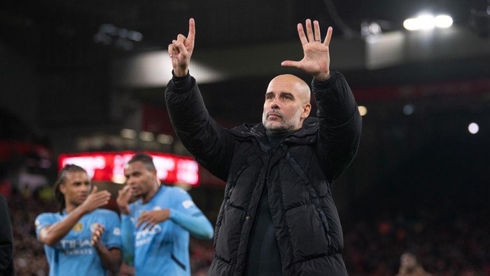 LIVERPOOL, ENGLAND - DECEMBER 1: Manchester City manager Pep Guardiola holds up six fingers to the fans indicating the number of Premier League titles he has won after the Premier League match between Liverpool FC and Manchester City FC at Anfield on December 1, 2024 in Liverpool, England. (Photo by Visionhaus/Getty Images)