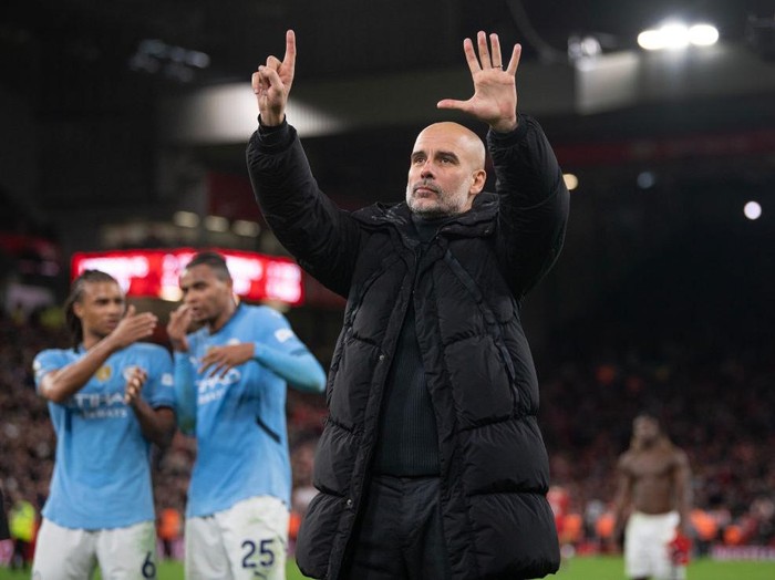 LIVERPOOL, ENGLAND - DECEMBER 1: Manchester City manager Pep Guardiola holds up six fingers to the fans indicating the number of Premier League titles he has won after the Premier League match between Liverpool FC and Manchester City FC at Anfield on December 1, 2024 in Liverpool, England. (Photo by Visionhaus/Getty Images)