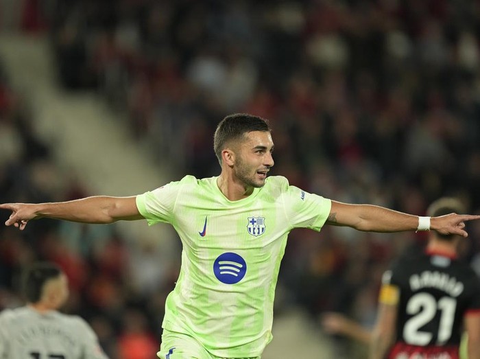 Barcelona's Ferran Torres celebrates after scoring the opening goal during a Spanish La Liga soccer match between Mallorca and Barcelona at the Son Moix stadium in Palma de Mallorca, Spain, Tuesday, Dec. 3, 2024. (AP Photo/Jose Breton)