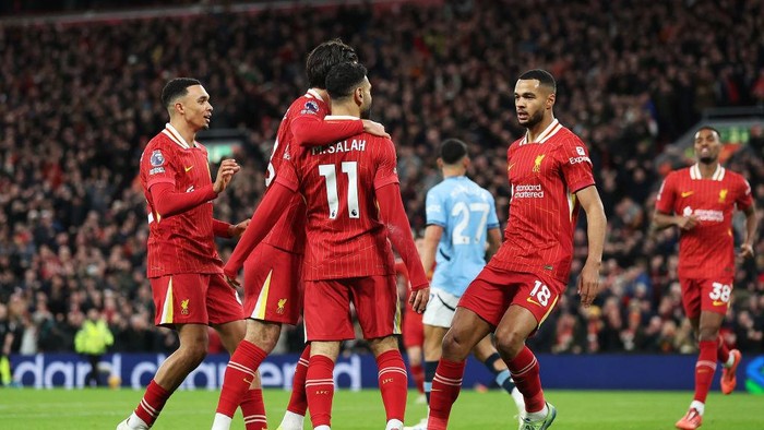  Cody Gakpo of Liverpool celebrates scoring his team's first goal with Dominik Szoboszlai and Mohamed Salah during the Premier League match between Liverpool FC and Manchester City FC at Anfield on December 01, 2024 in Liverpool, England. (Photo by Carl Recine/Getty Images)